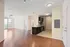 Bright apartment with open-concept living area, modern kitchen with sleek cabinetry, and elegant wood flooring.