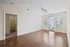 Bright and airy living room with large windows, hardwood floors, and modern lighting, offering a blank canvas for your dream home decor.