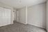 Cozy bedroom with plush carpeting and ample closet space, perfect for stylish living.