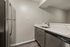 Modern kitchen with stainless steel appliances, sleek cabinetry, and elegant marble countertops.