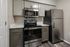 Contemporary kitchen with sleek stainless steel appliances, stylish subway tile backsplash, and elegant cabinetry for a modern touch.