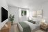 Tranquil bedroom with modern decor, featuring a comfortable king-sized bed, chic wooden furniture, large TV, and soft natural lighting.