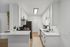 Sleek modern kitchen with white cabinetry, stainless steel appliances, and elegant countertops, perfect for culinary creativity.