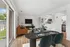 Modern open-concept living and dining area with stylish furnishings and stainless steel kitchen appliances.