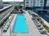 Contemporary urban apartment with a luxurious rooftop pool, stylish lounge chairs, and stunning city views.