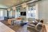 Sophisticated living room with modern decor, featuring a plush sofa, elegant dining area, and stylish lighting under a spacious, open floor plan.