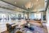 Elegant and modern lounge with plush seating, chic lighting, and expansive glass partitions offering a spacious, airy feel.