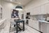 Modern kitchen with sleek cabinetry, chic geometric backsplash, and stylish pendant lighting, perfect for apartment living.