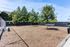 Inviting outdoor area featuring a well-maintained open space with benches, lush greenery, and a sturdy perimeter fence, perfect for relaxation and recreation.