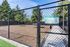 Spacious and inviting dog park with secure fencing, surrounded by lush trees for an engaging pet-friendly experience.