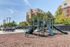 Inviting playground with slides and climbing structures set in a vibrant residential community, perfect for family-friendly living.