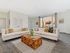 Bright and inviting living room featuring elegant cream sofas and a unique wooden coffee table, framed by large windows with a charming urban view.