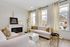 Elegant living room with stylish decor, featuring plush seating, modern fireplace, and large windows providing abundant natural light.