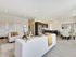 Modern open-concept living area with elegant seating, stylish kitchen, and chic dining space.