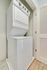 Compact laundry area with a sleek, stackable washer and dryer unit, perfect for efficient living.