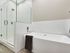 Modern bathroom featuring a sleek freestanding bathtub and a spacious glass-enclosed shower with elegant fixtures.