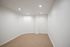 Bright, spacious room with clean white walls and soft carpeting, ideal for a cozy living space or home office.