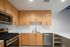 Modern kitchen with sleek stainless steel appliances, elegant wooden cabinets, and pristine countertops, offering both style and functionality.