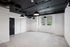 Modern open space with industrial ceiling design, large windows, and sleek lighting fixtures, offering a blank canvas for personalized interior design.