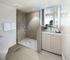 Contemporary bathroom with sleek glass shower enclosure, modern vanity, and elegant tile flooring.