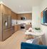 Modern kitchen with sleek stainless steel appliances, elegant wooden cabinetry, and a cozy breakfast nook with stylish decor.