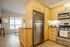 Bright, modern kitchen with stainless steel appliances, sleek wood cabinetry, and an inviting open layout perfect for entertaining.