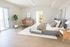 Bright and airy bedroom with modern decor, featuring a plush bed, stylish wooden furniture, and a sliding glass door leading to a balcony.