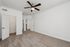 Bright, spacious bedroom with plush carpet, classic crown molding, and sleek ceiling fan.
