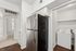 Modern apartment kitchen with stainless steel refrigerator, sleek cabinetry, and a convenient laundry nook for easy living.
