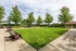 Lush outdoor green space with elegant seating areas, shaded pavilions, and manicured lawns perfect for relaxation and gatherings.