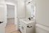 Modern bathroom with sleek fixtures and a bright, spacious layout, featuring a large mirror and contemporary sink design.
