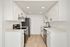 Sleek modern kitchen with white cabinetry, stainless steel appliances, and elegant black fixtures.