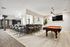 Luxurious recreation room featuring a sleek pool table, stylish bar area with high chairs, and a modern TV setup.