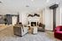 Luxurious apartment lounge featuring plush seating, elegant fireplace, and modern decor accents.