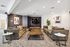 Sophisticated living room with plush sofas, modern decor, and a large wall-mounted TV, perfect for relaxation and entertainment.