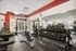 Modern fitness center with state-of-the-art equipment, free weights, and bright, welcoming space.