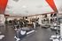 Modern fitness center with state-of-the-art exercise equipment, including treadmills and weight machines, in a spacious and well-lit environment.