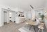 Bright and modern living room with open dining area, sleek kitchen bar, and elegant decor, perfect for entertaining and relaxation.