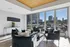 Bright and inviting living space with modern seating, large windows, and cityscape views.