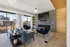 Modern living room with sleek furnishings, large windows, and a stylish fireplace, offering a perfect blend of comfort and elegance.