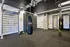 Chic fitness room equipped with modern gym apparatus, punching bag, and an indoor climbing wall, ideal for a dynamic workout experience.
