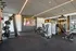 Modern fitness center with state-of-the-art exercise equipment, sleek design, and large screen for immersive workout sessions.