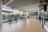 Bright modern fitness room featuring exercise bikes, large windows with a scenic view, and a sleek design.