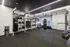 Modern fitness room equipped with punching bags, weights, and gym accessories, ideal for a dynamic workout.