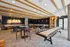 Modern recreational lounge with sleek game tables, stylish bar seating, and elegant lighting.