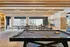 Chic recreation room with a sleek pool table, elegant seating area, and modern fireplace, offering a luxurious relaxation space.