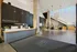 Elegant and modern apartment lobby featuring a welcoming reception desk, stylish hanging chairs, and artistic staircase design.