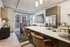 Modern apartment with open-concept kitchen, sleek countertops, and stylish furnishings, complemented by floor-to-ceiling windows and warm lighting.