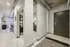 Modern apartment entrance with sleek corridor, stylish decor, and an inviting open-concept living area.