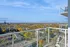 Stunning high-rise balcony view showcasing a vibrant fall landscape with city skyline in the distance.